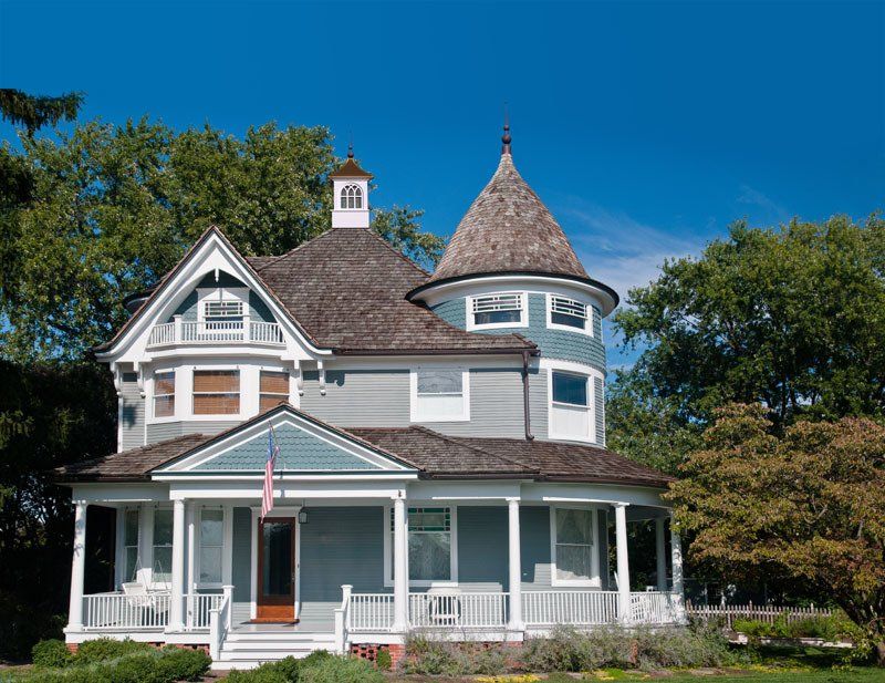 A large house with a round tower on top of it.