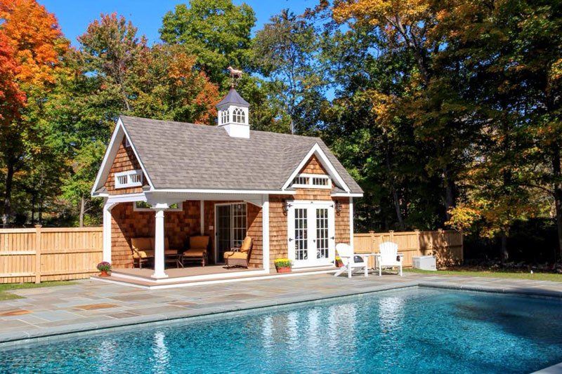 A house with a swimming pool in front of it
