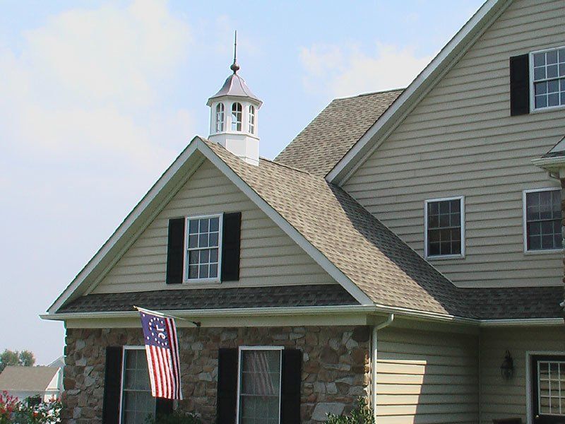 A house with a cupola on top of it