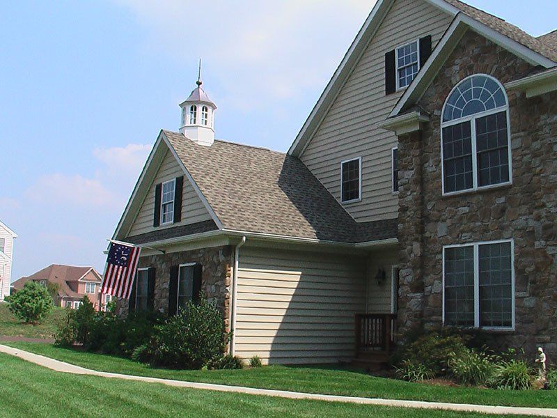 A large house with an american flag in front of it
