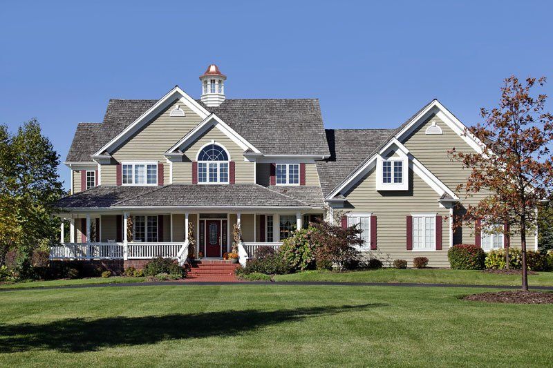 A large house with a large lawn in front of it