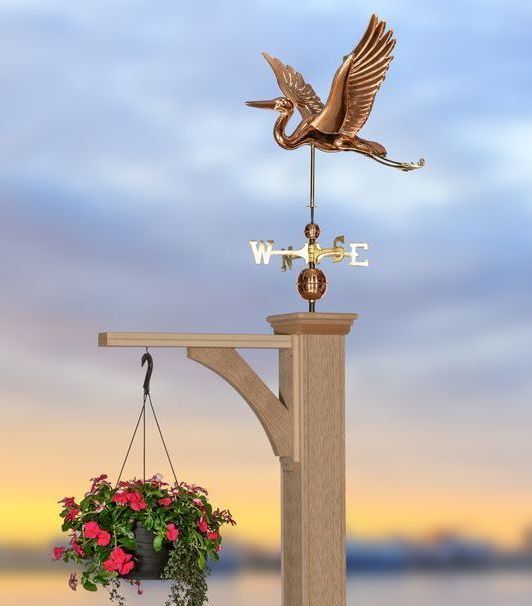 A weather vane with a bird on top that says wise