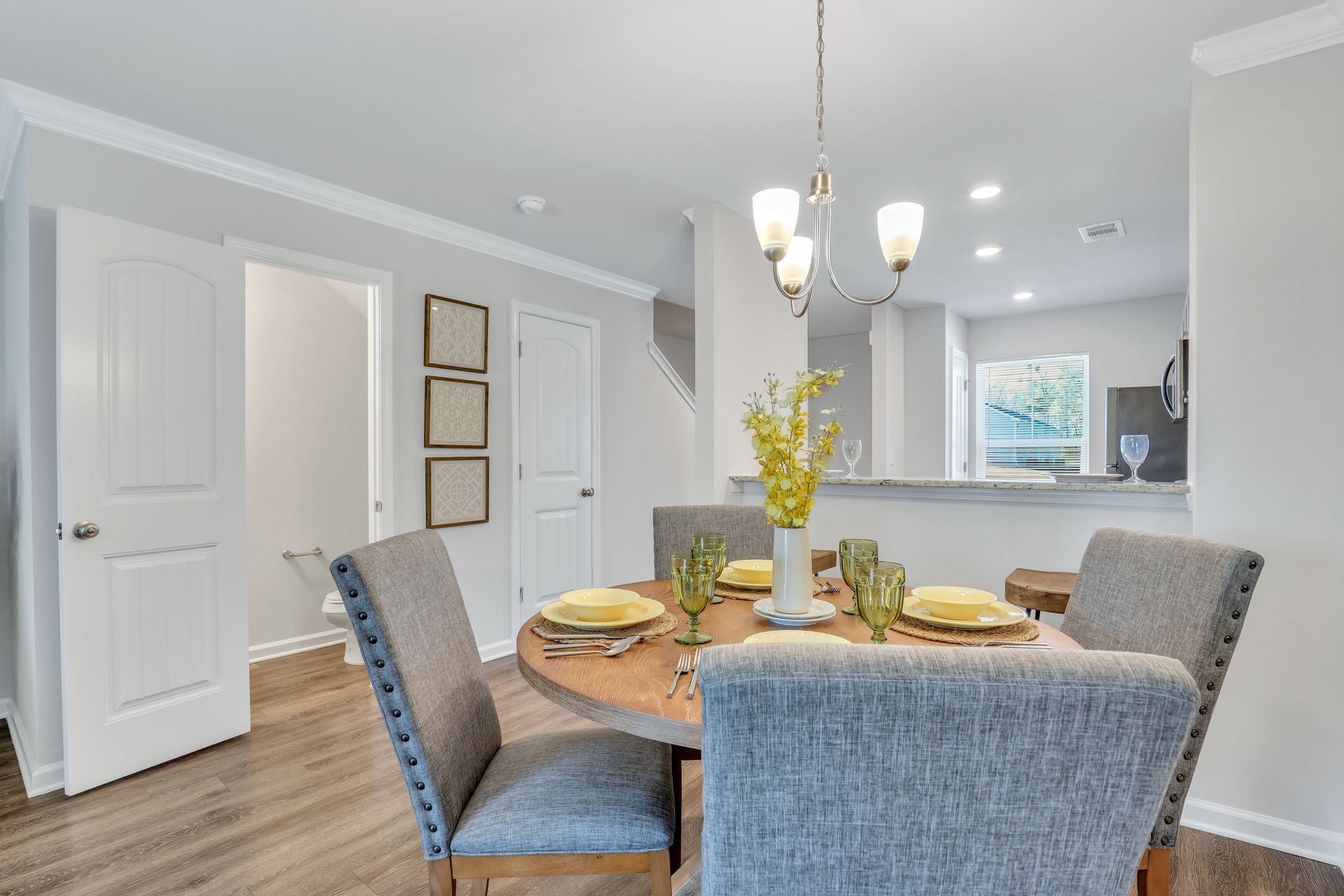 A dining room with a table and chairs and a chandelier.
