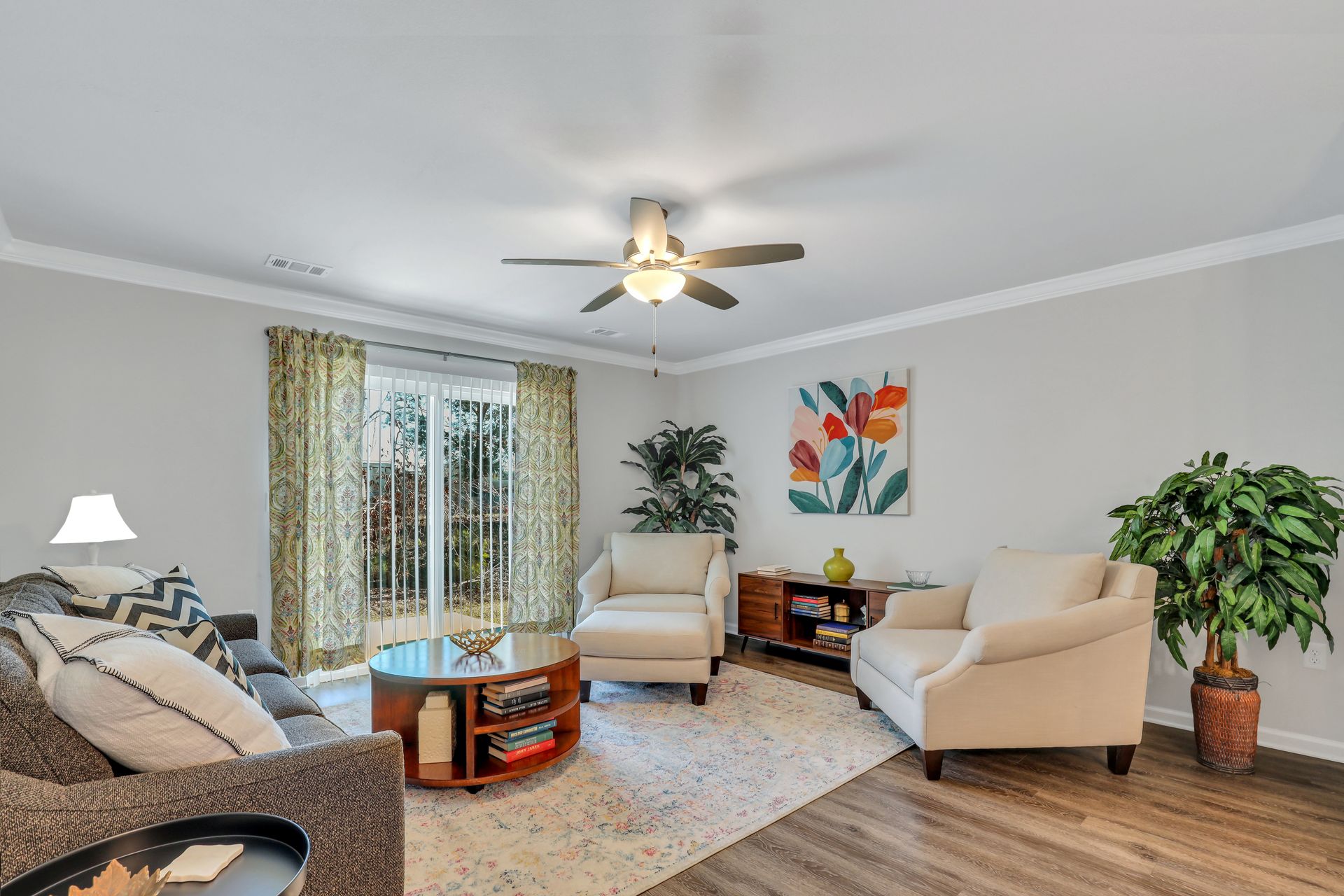 A living room filled with furniture and a ceiling fan.