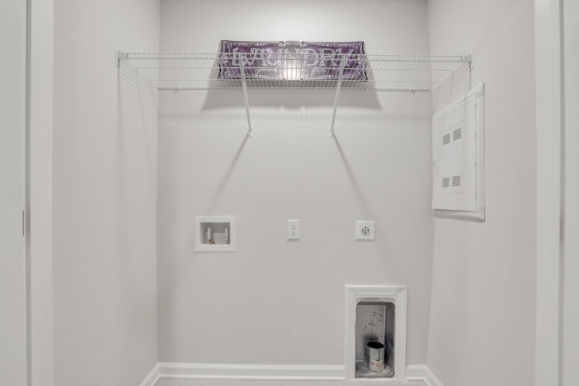 A laundry room in a house with a washer and dryer.