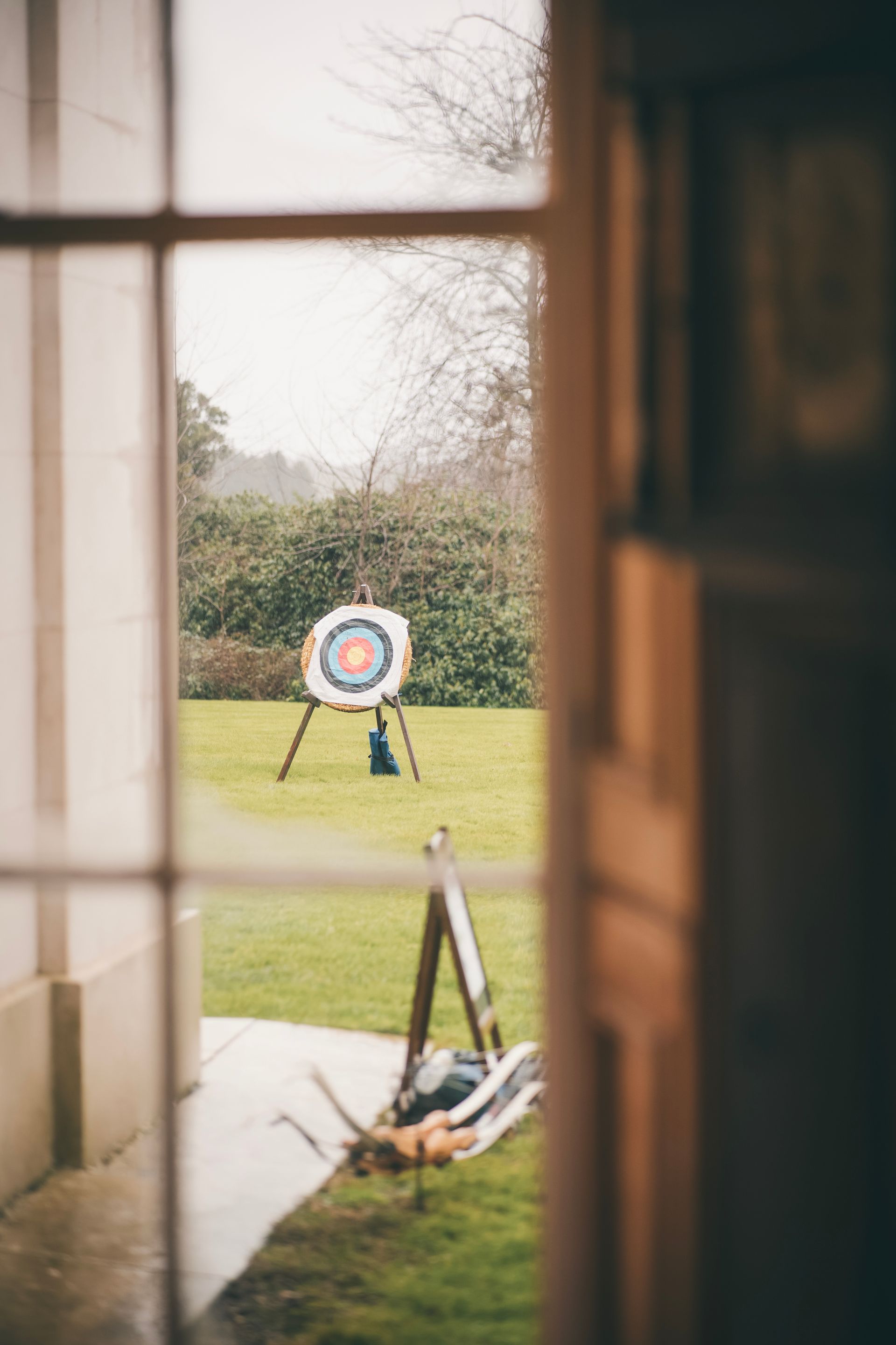 An archery target and stand on a field being looked at through a window in Hampshire