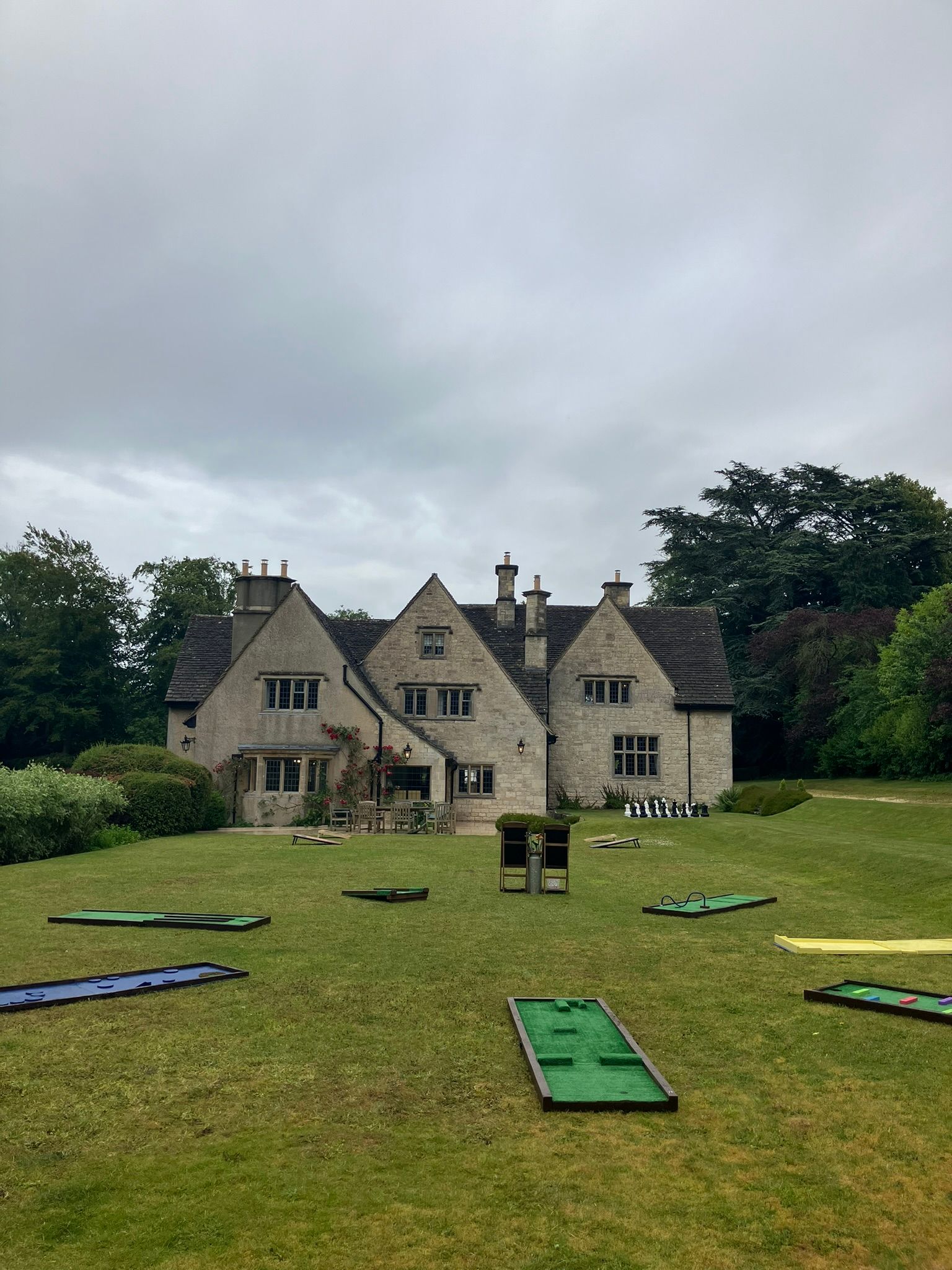 Crazy golf and giant chess on grass in front of a house.