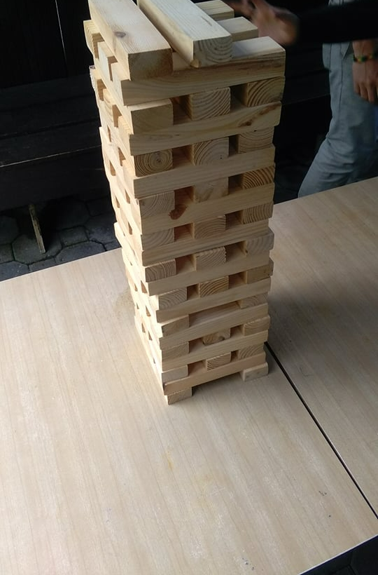 Giant wooden jenga set up on a table