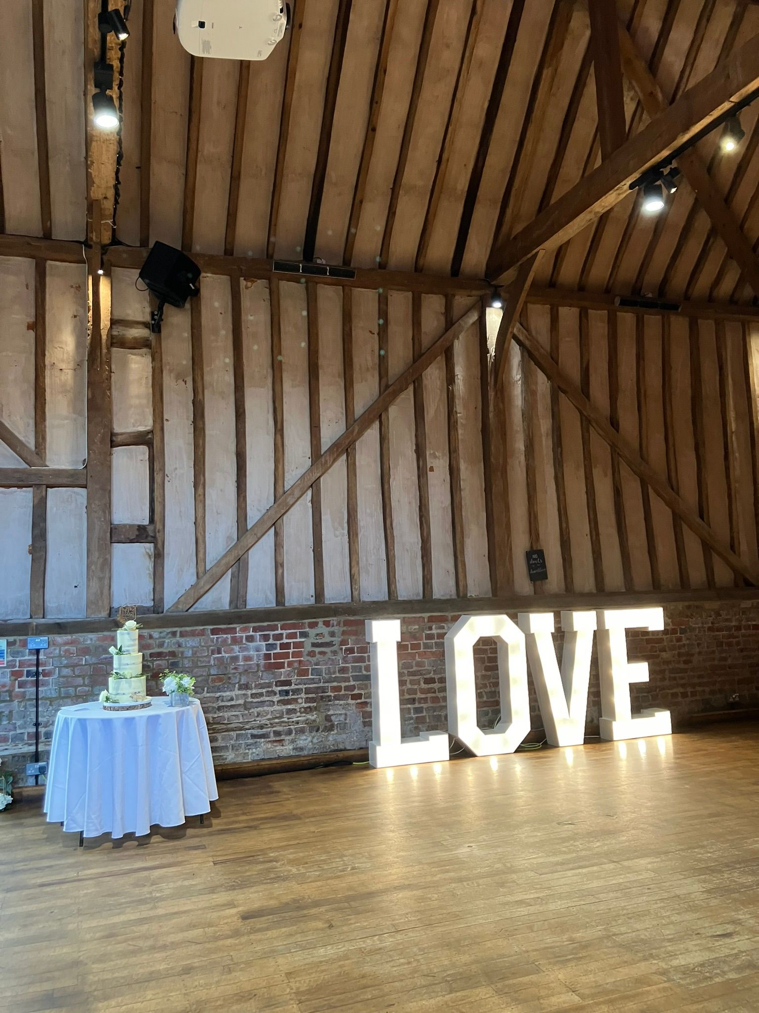 LOVE lights in a barn next to the dance floor.