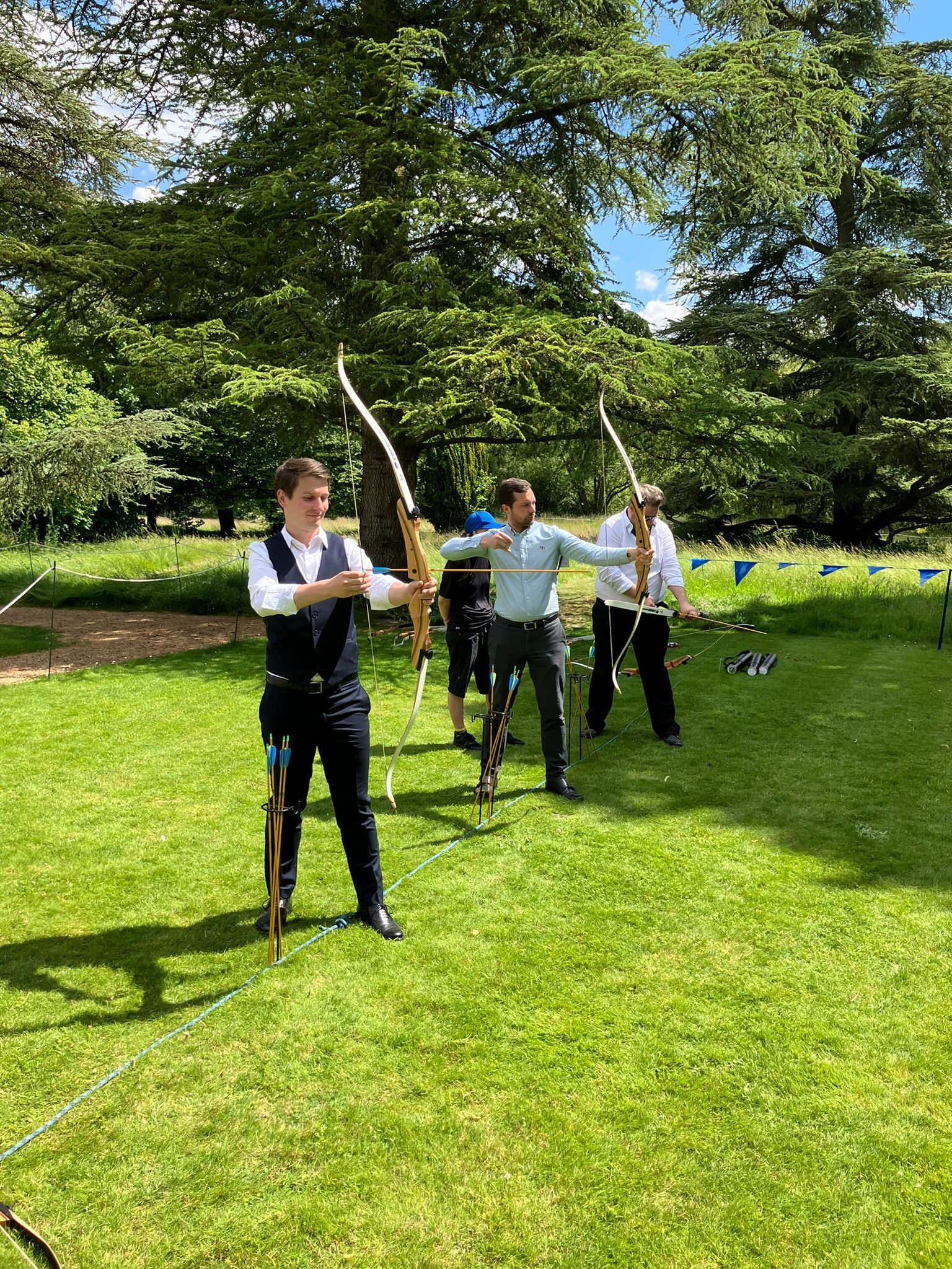 Archery hire in Hampshire, people holding bows and others watching