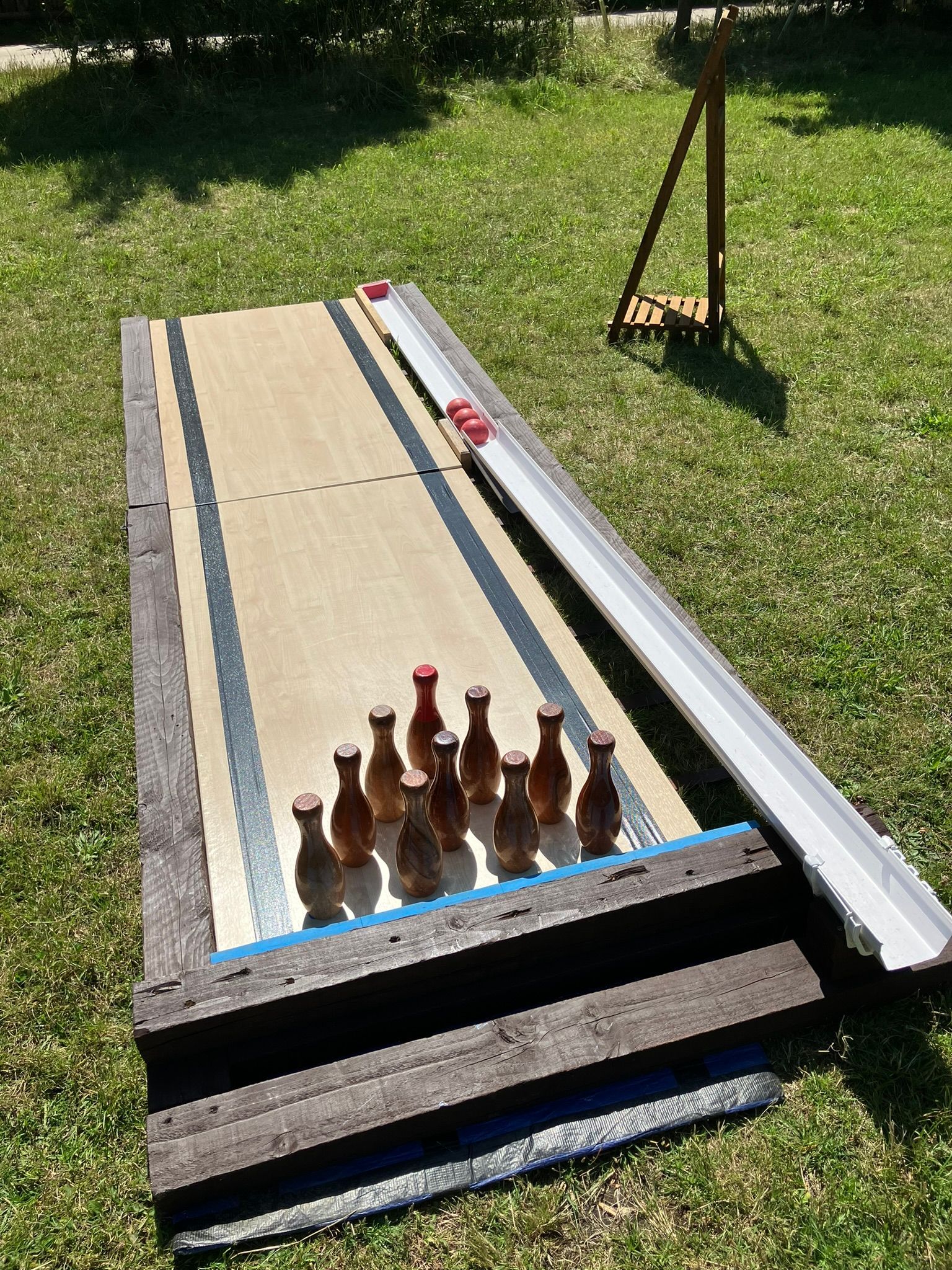 Wooden skittle alley on grass