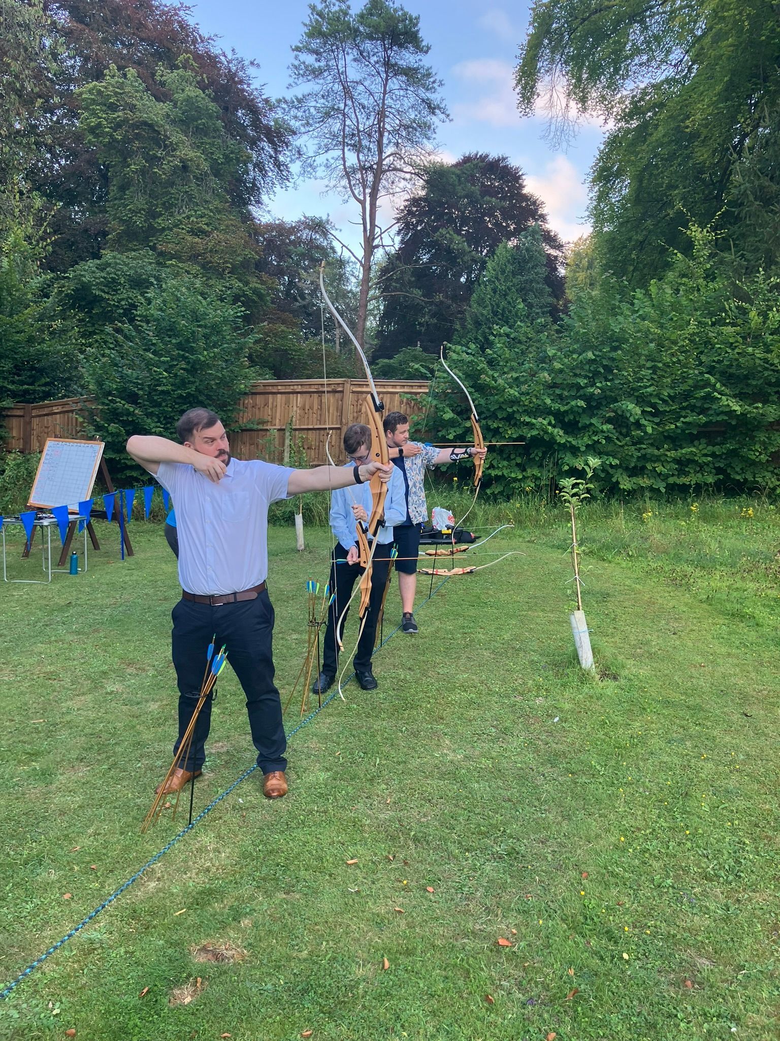 Archery hire in Hampshire, people holding bows and others watching