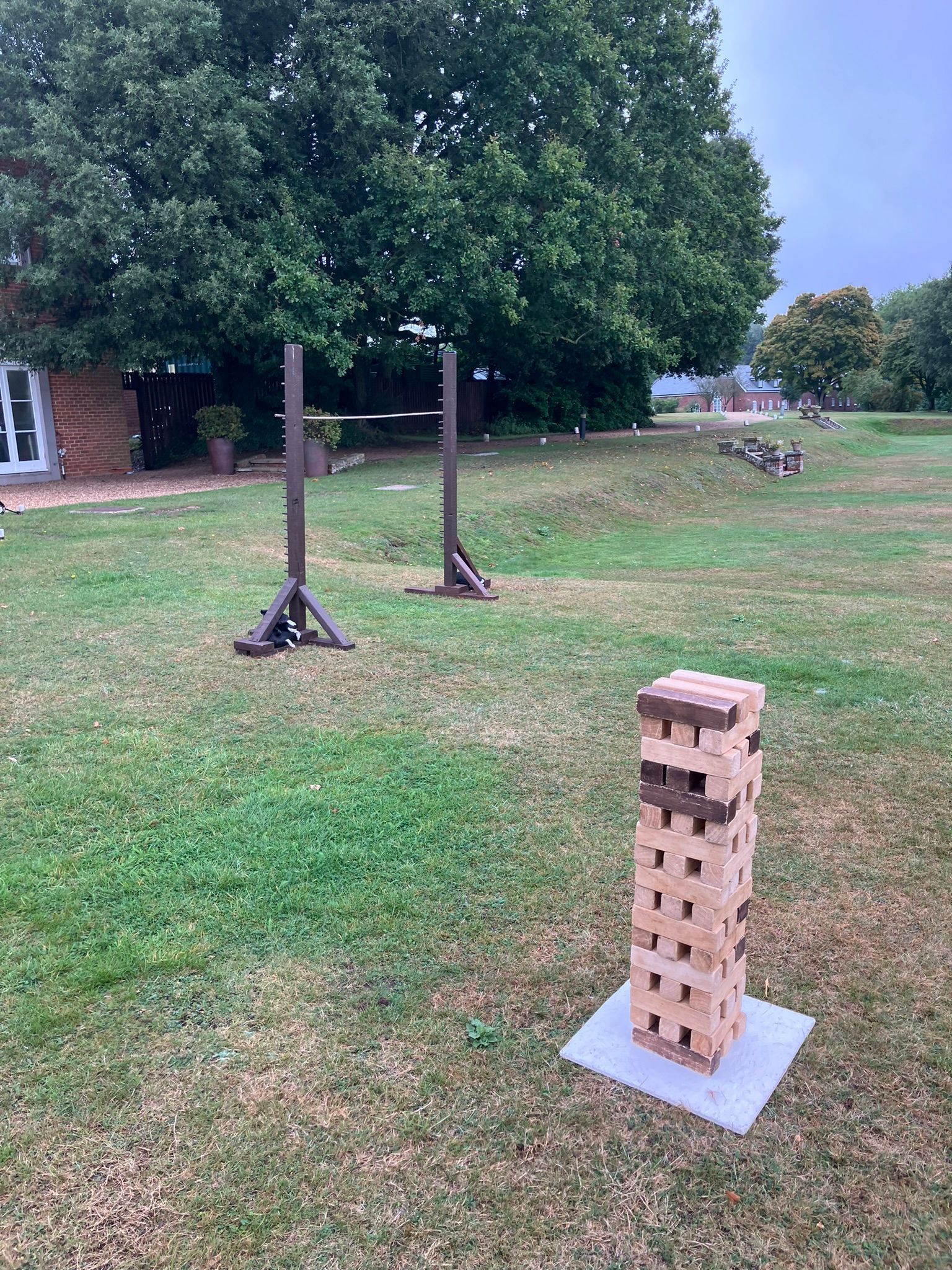 Wooden limbo game in a garden.