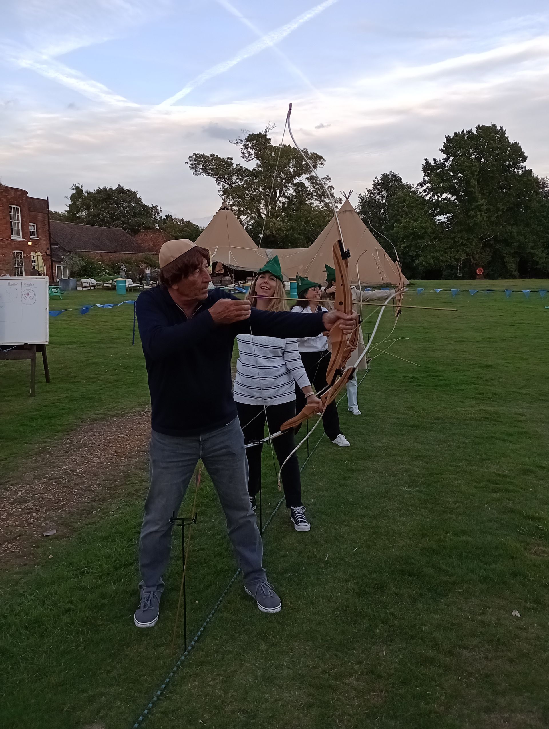Robin Hood theme corporate archery at Stoke Place hotel.  4 group members holding archery bows.