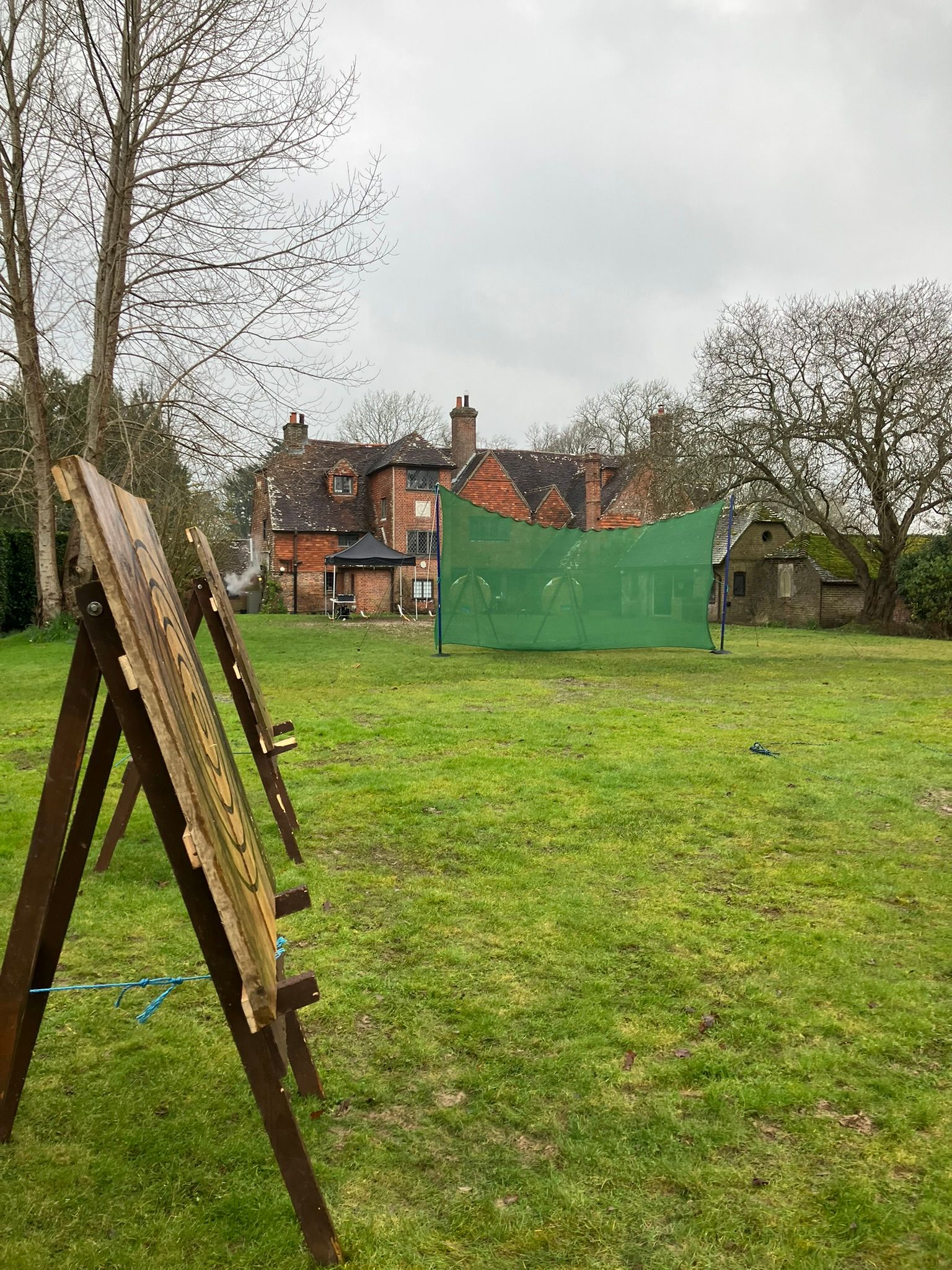 Axe throwing and archery targets set up on a field for a corporate event in Hampshire