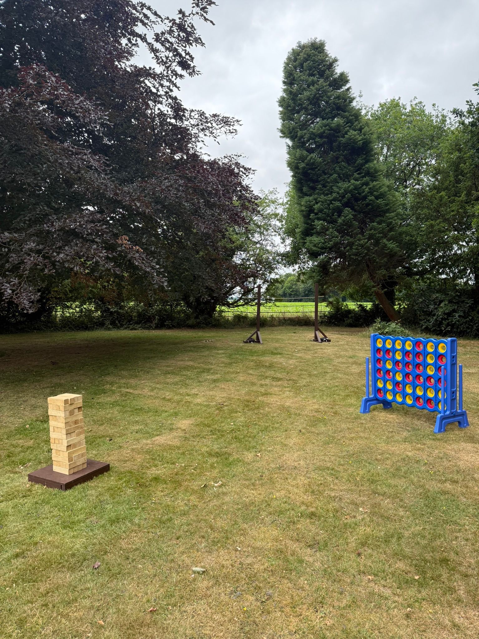 GO Event Hire lawn games set up on a field.  Giant jenga, Limbo and Giant connect 4.