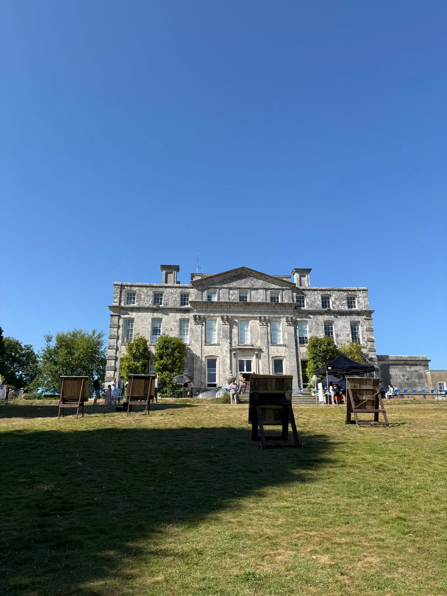 Corporate axe throwing hire in Hampshire. 4 targets set up on grass at a hotel.