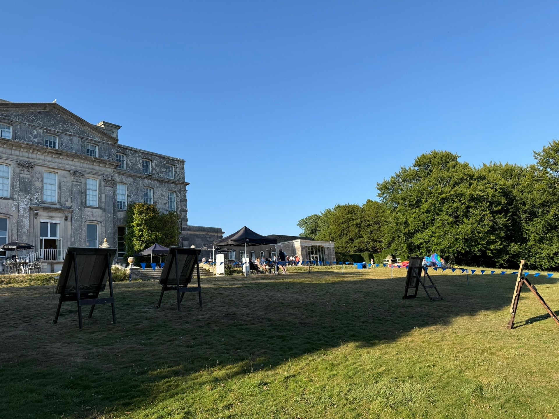 Corporate axe throwing hire in Hampshire. 4 targets set up on grass at a hotel.
