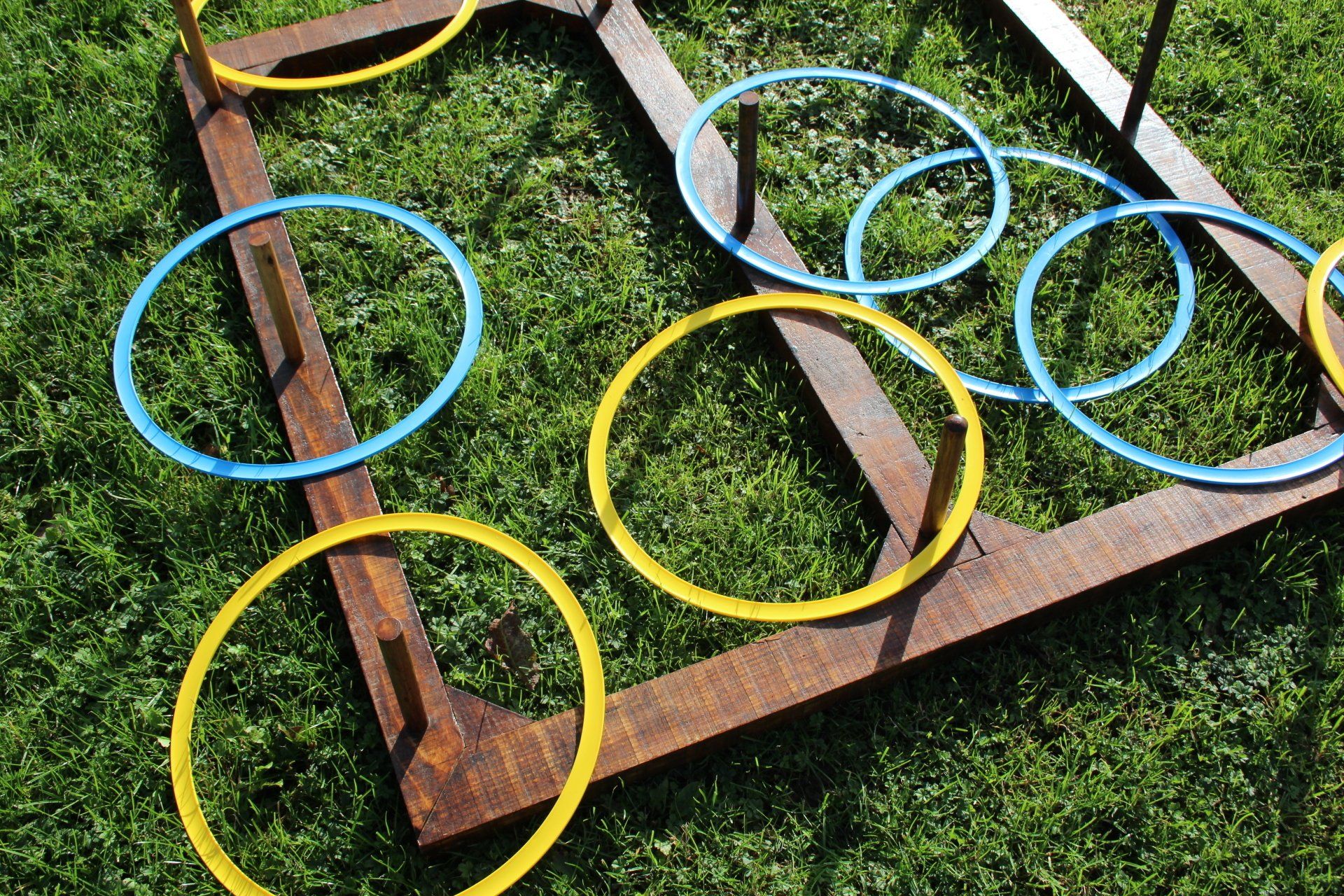 Wooden frame with large plastic coloured hoops.