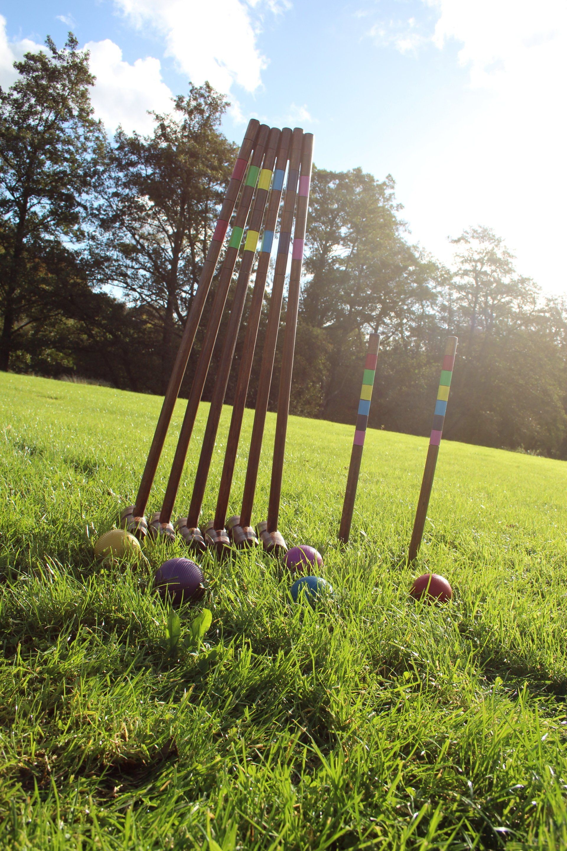 Lawn game of croquet on a field.
