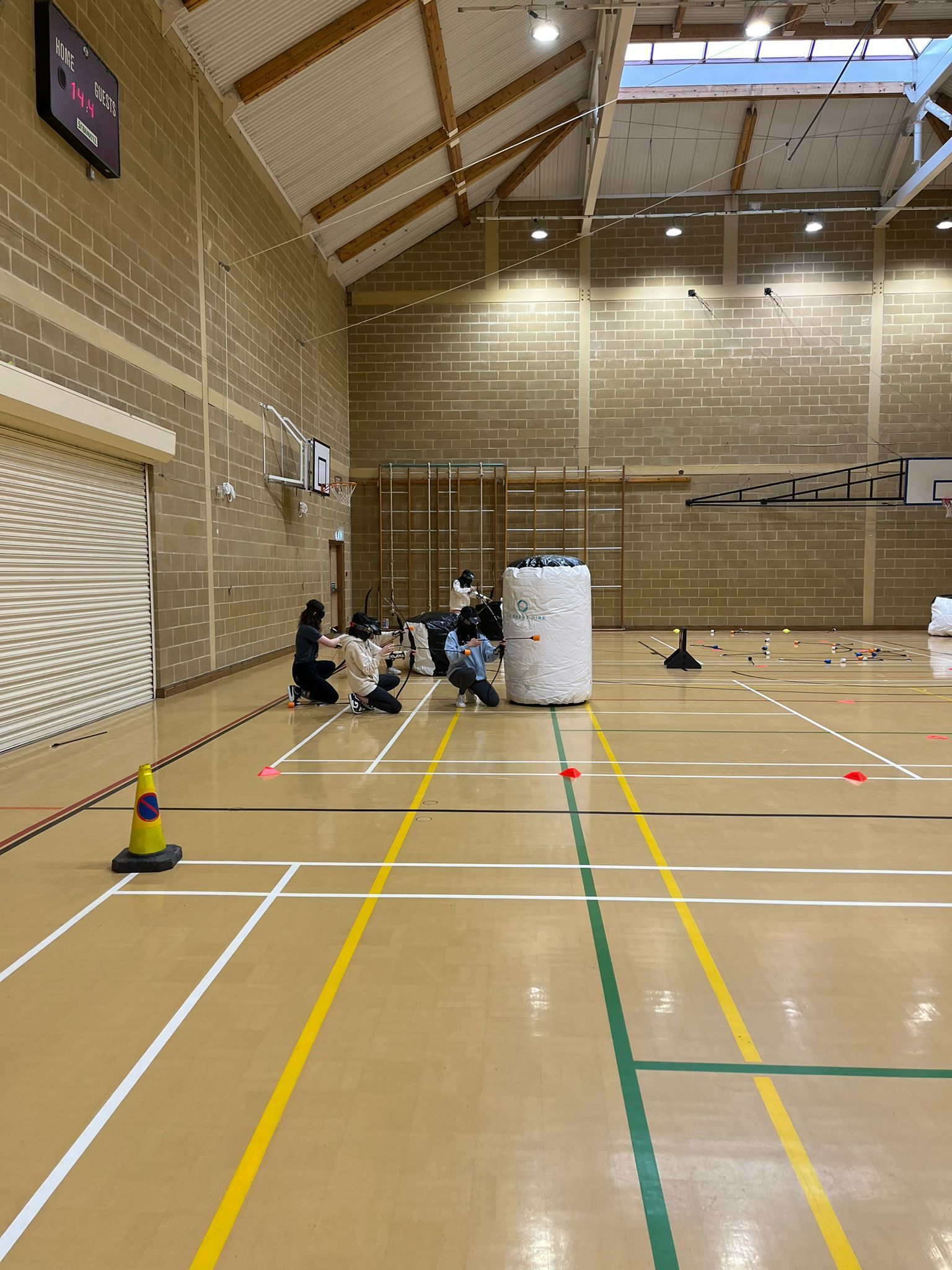 Archery tag set up in a sports hall.