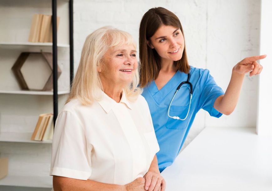 Friendly nurse guiding senior resident at Adrian Bay Rehab & Nursing Center