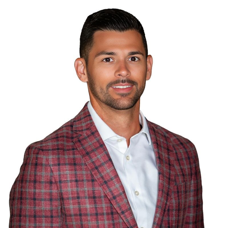 A man in a suit and tie is smiling for the camera.