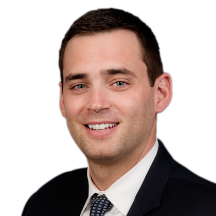 A man in a suit and tie is smiling for the camera.