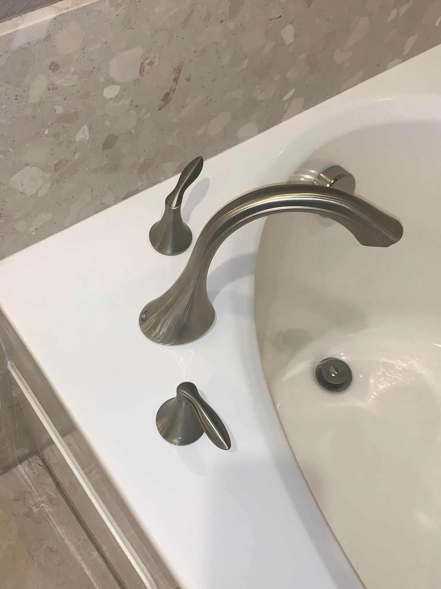 Bathroom sink with chrome faucet and separate hot and cold handles on a white countertop.