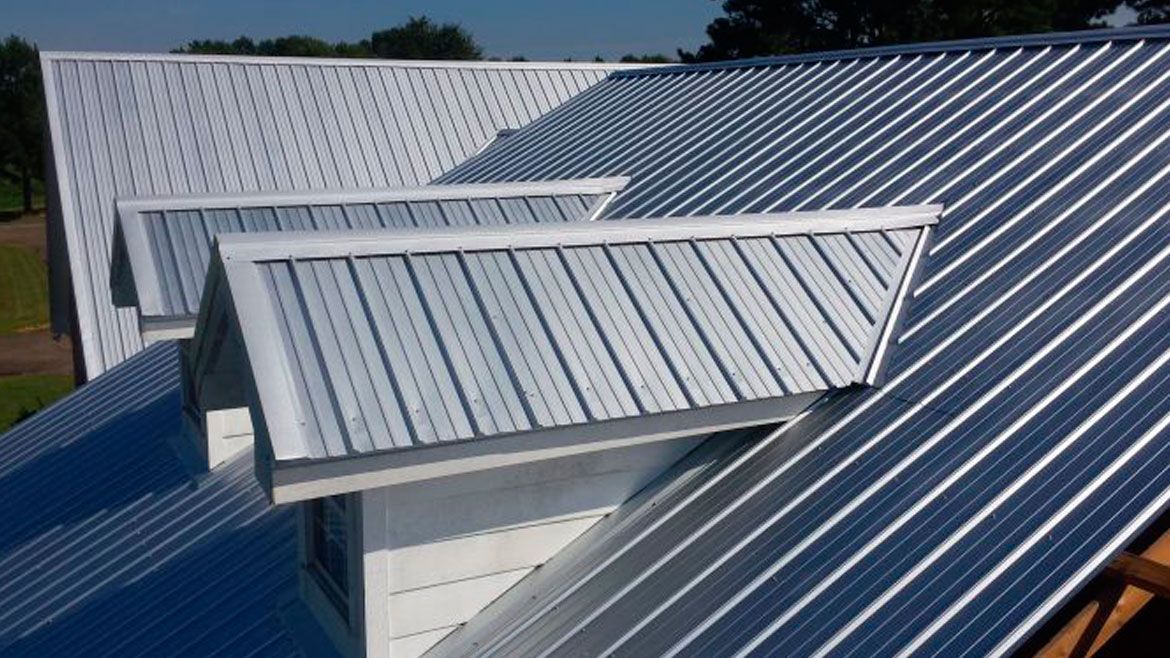 Metal rooftop with several skylights on a bright day