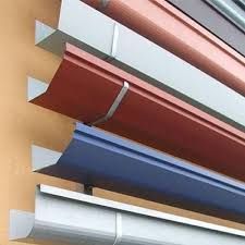 Stacked colorful metal awning panels in red, blue, and white, shown in close-up
