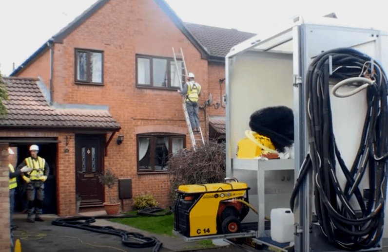 Cavity wall insulation being installed by contractors