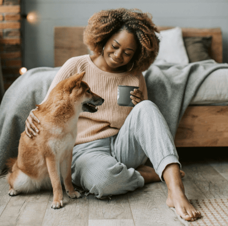 Woman and dog sitting on cosy insulated floorboards