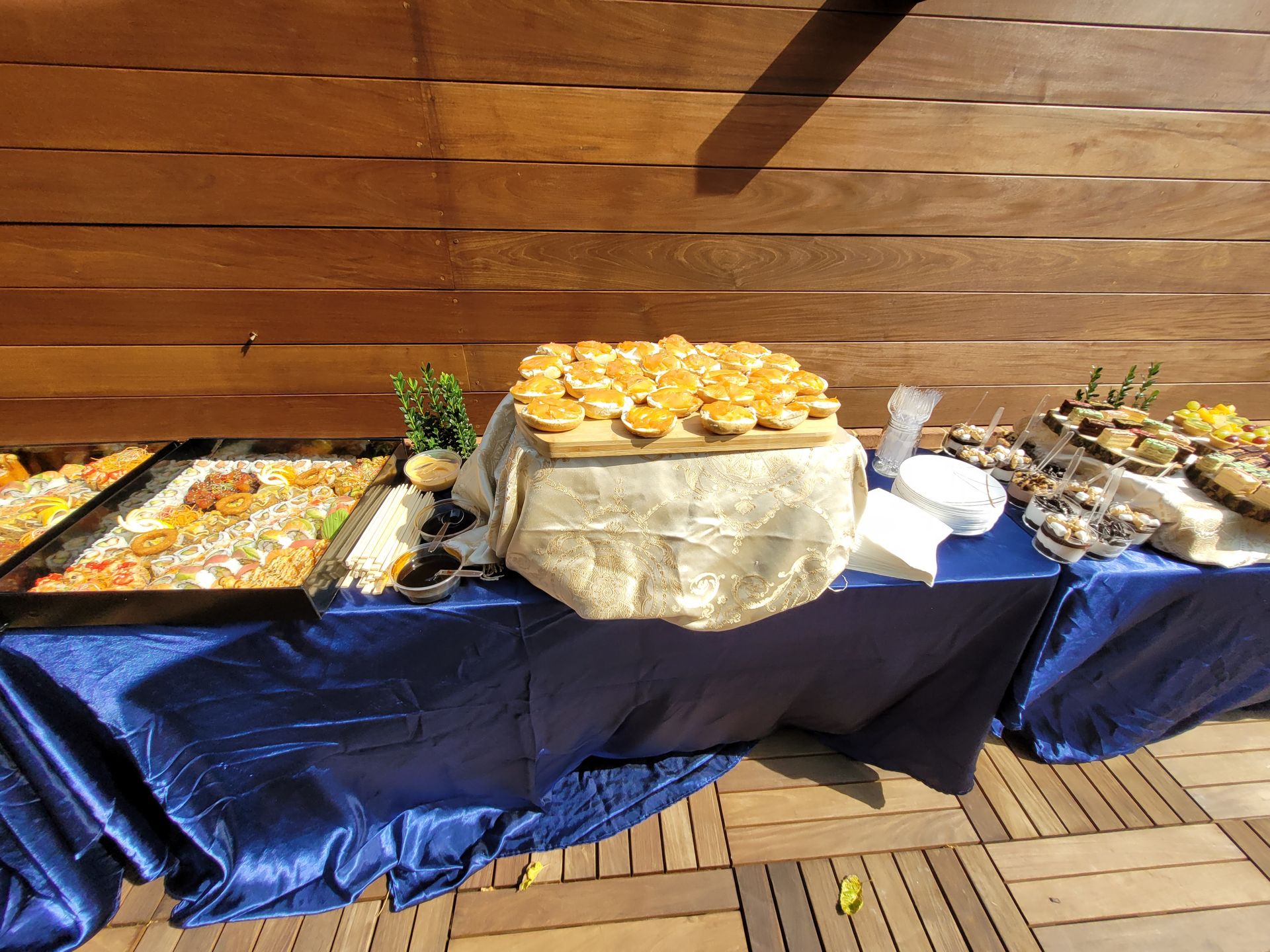 A table with a blue table cloth and a bunch of food on it
