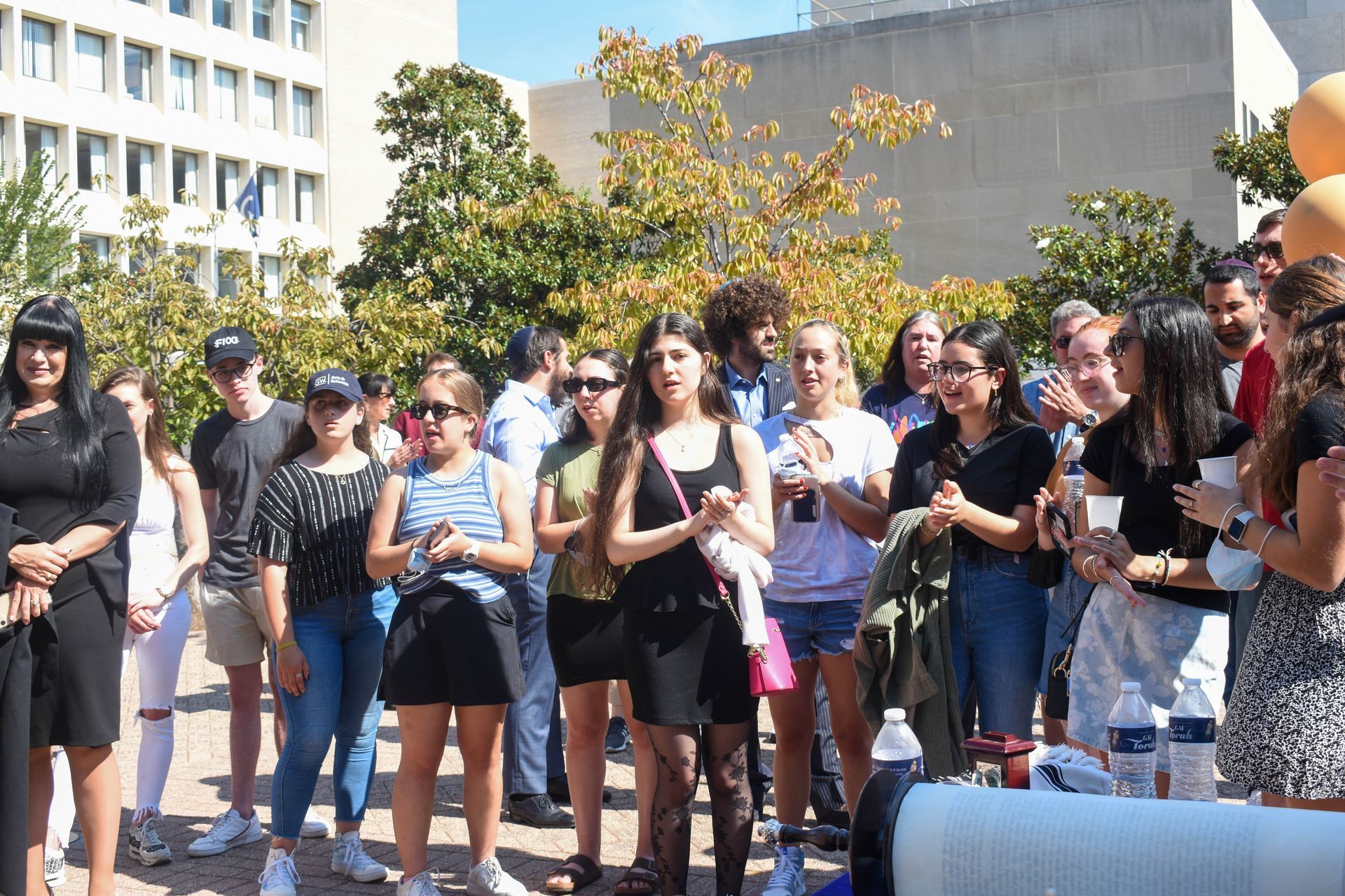 A group of people are standing in front of a building.