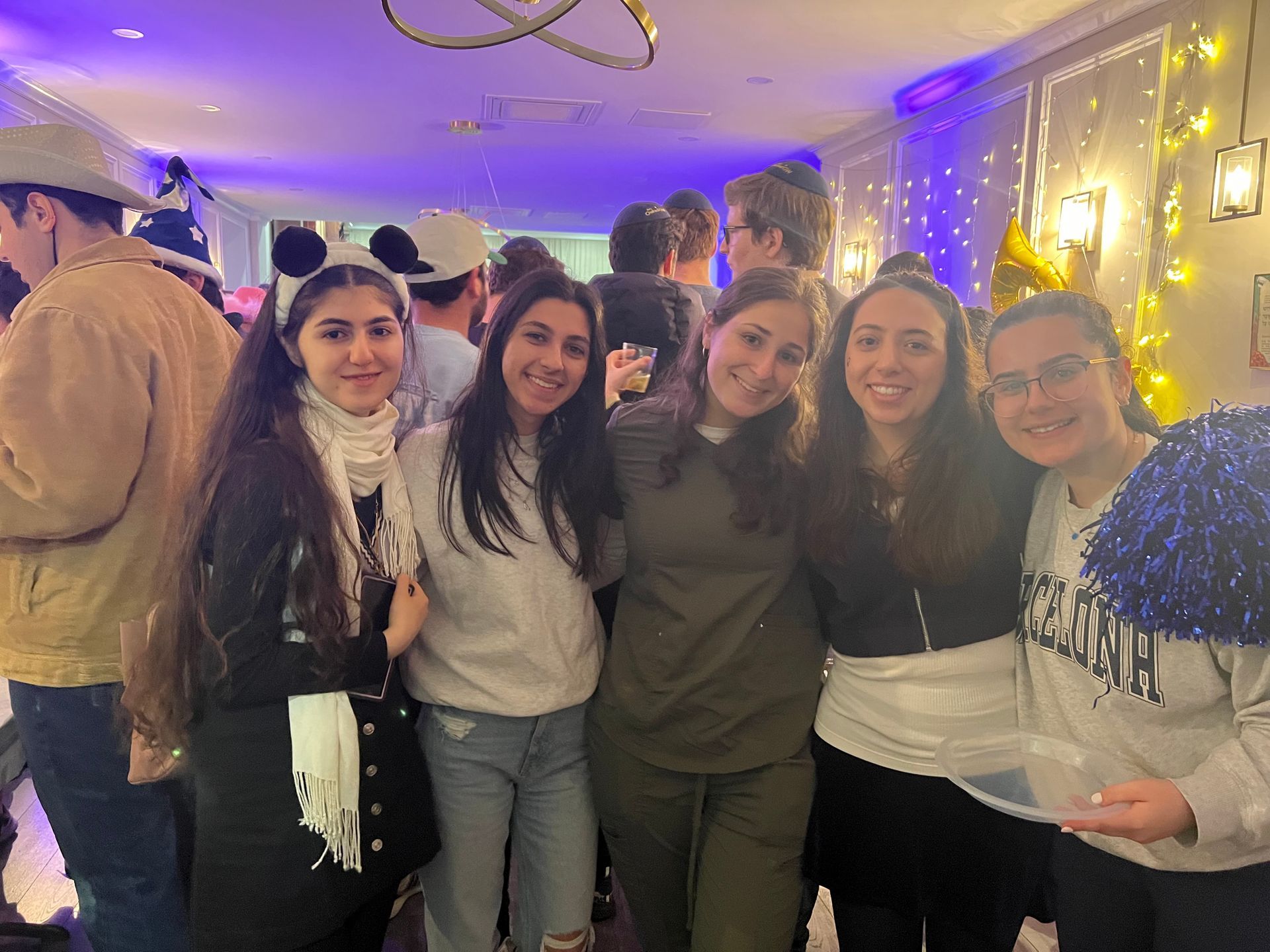 a group of young women are posing for a picture at a party .