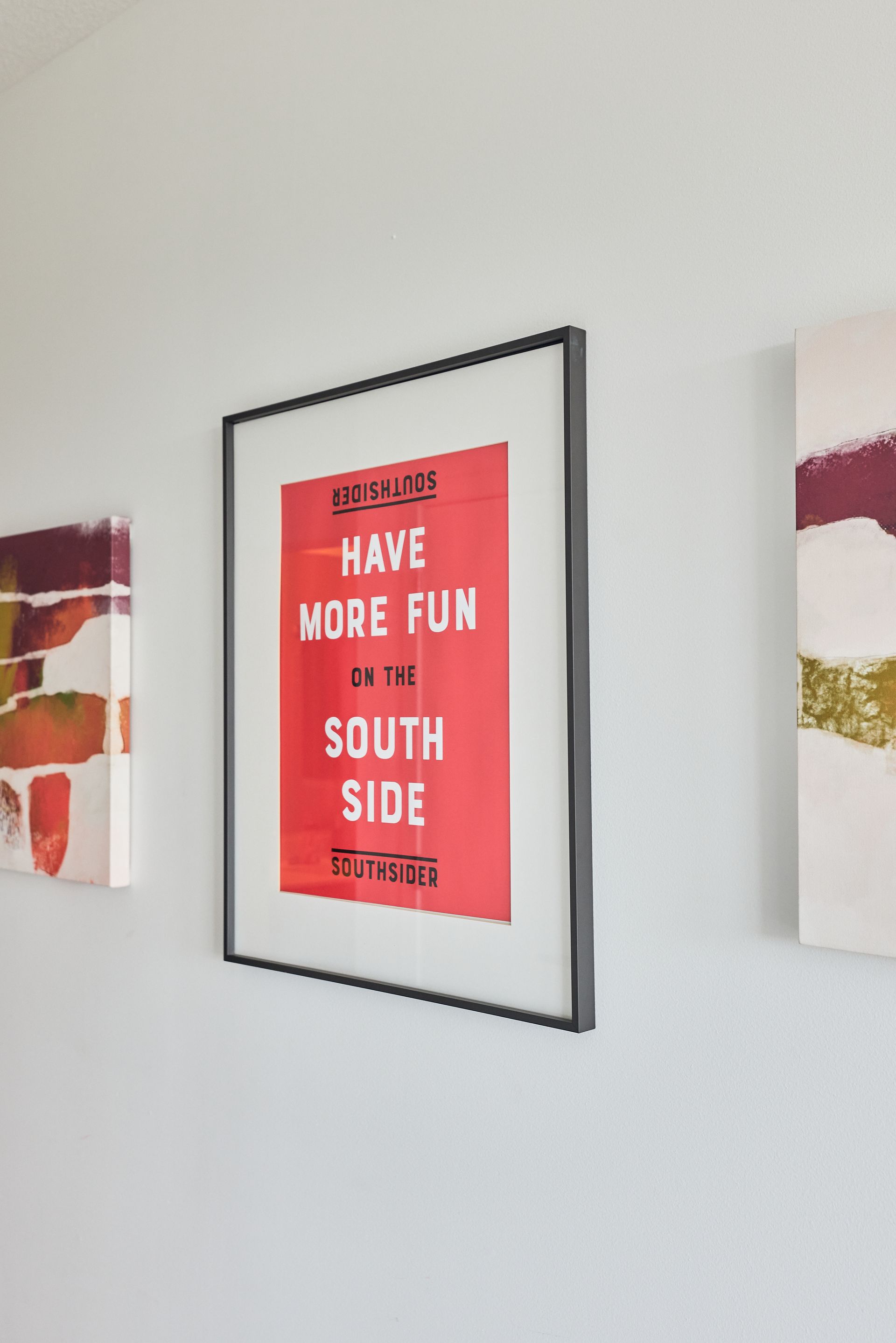 Red poster in black frame: 