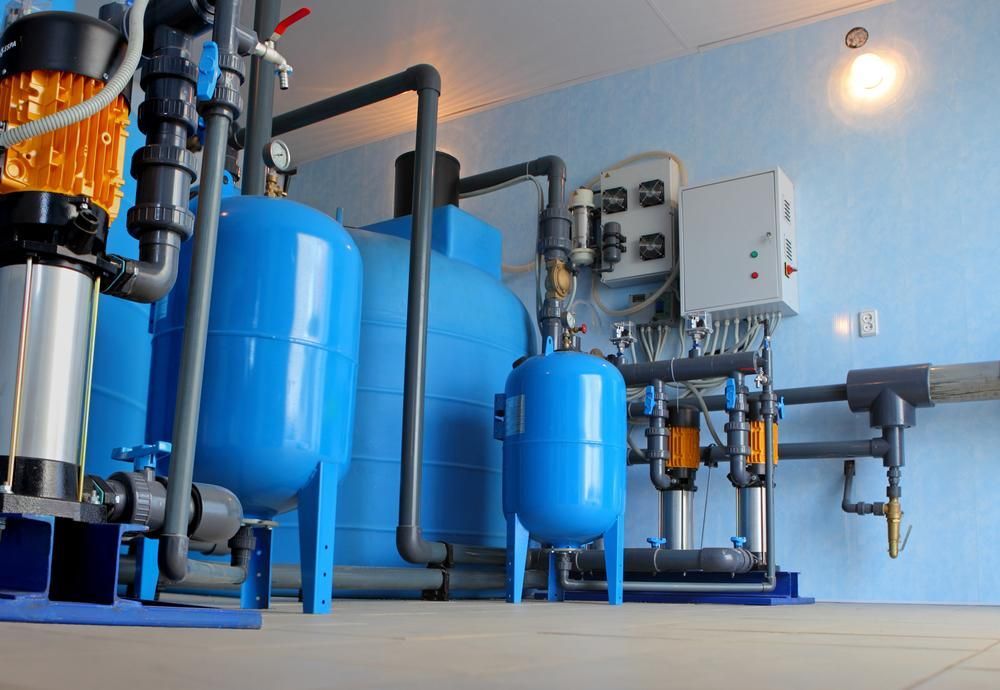 A Room With A Lot Of Blue Tanks And Pipes — All Bright Pool Care In Laurieton, NSW
