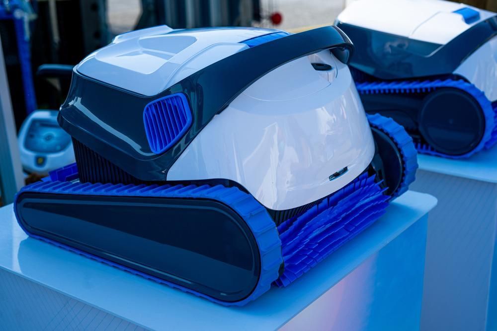 A White And Blue Robot Is Sitting On Top Of A White Table — All Bright Pool Care In Laurieton, NSW