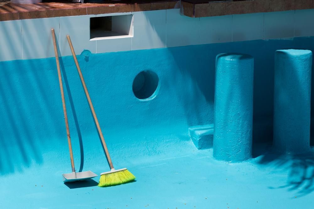 A Broom And A Shovel Are Sitting On The Floor Of A Swimming Pool — All Bright Pool Care In Laurieton, NSW