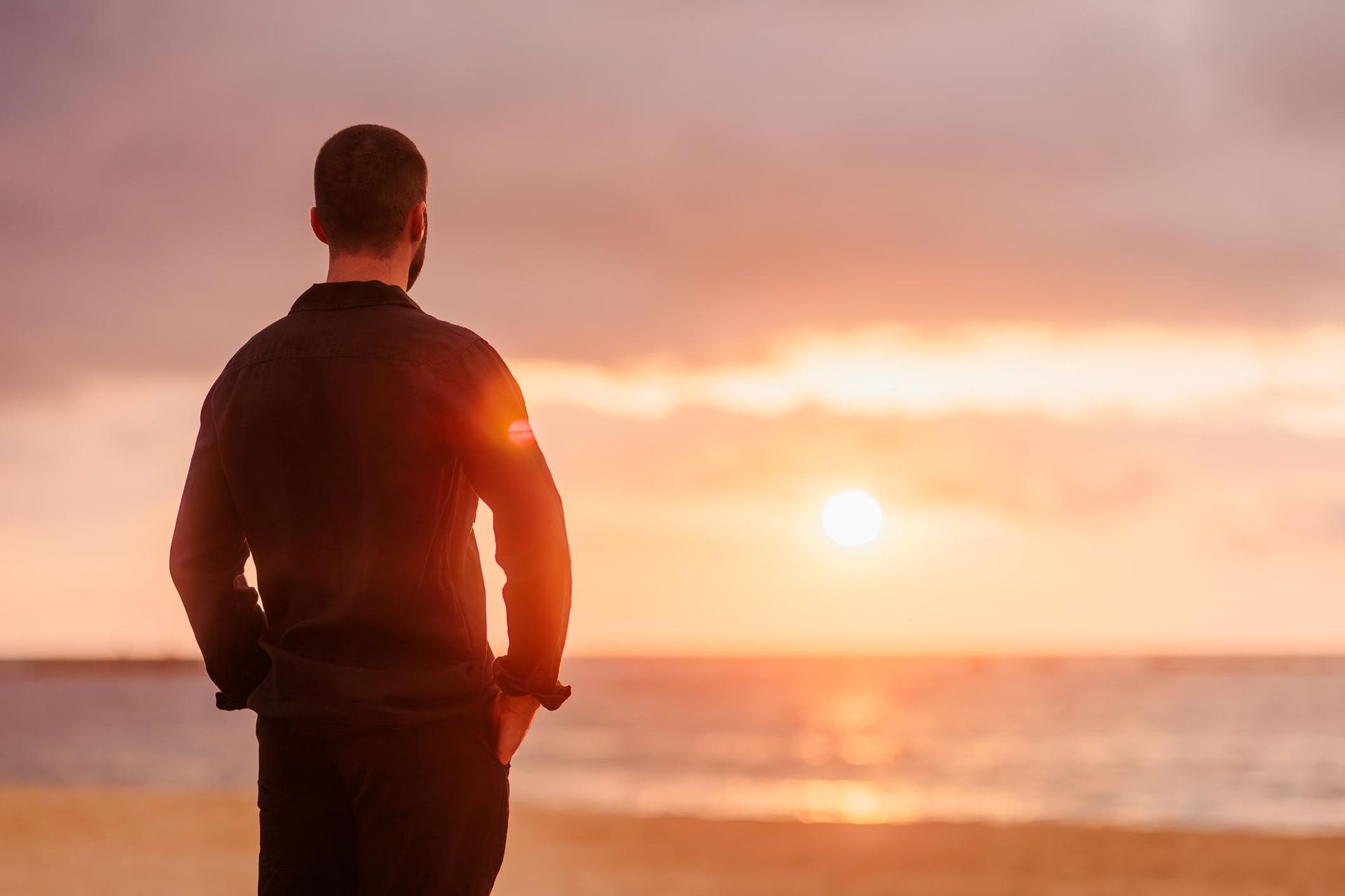 Person sitting peacefully in nature representing contentment and natural wealth