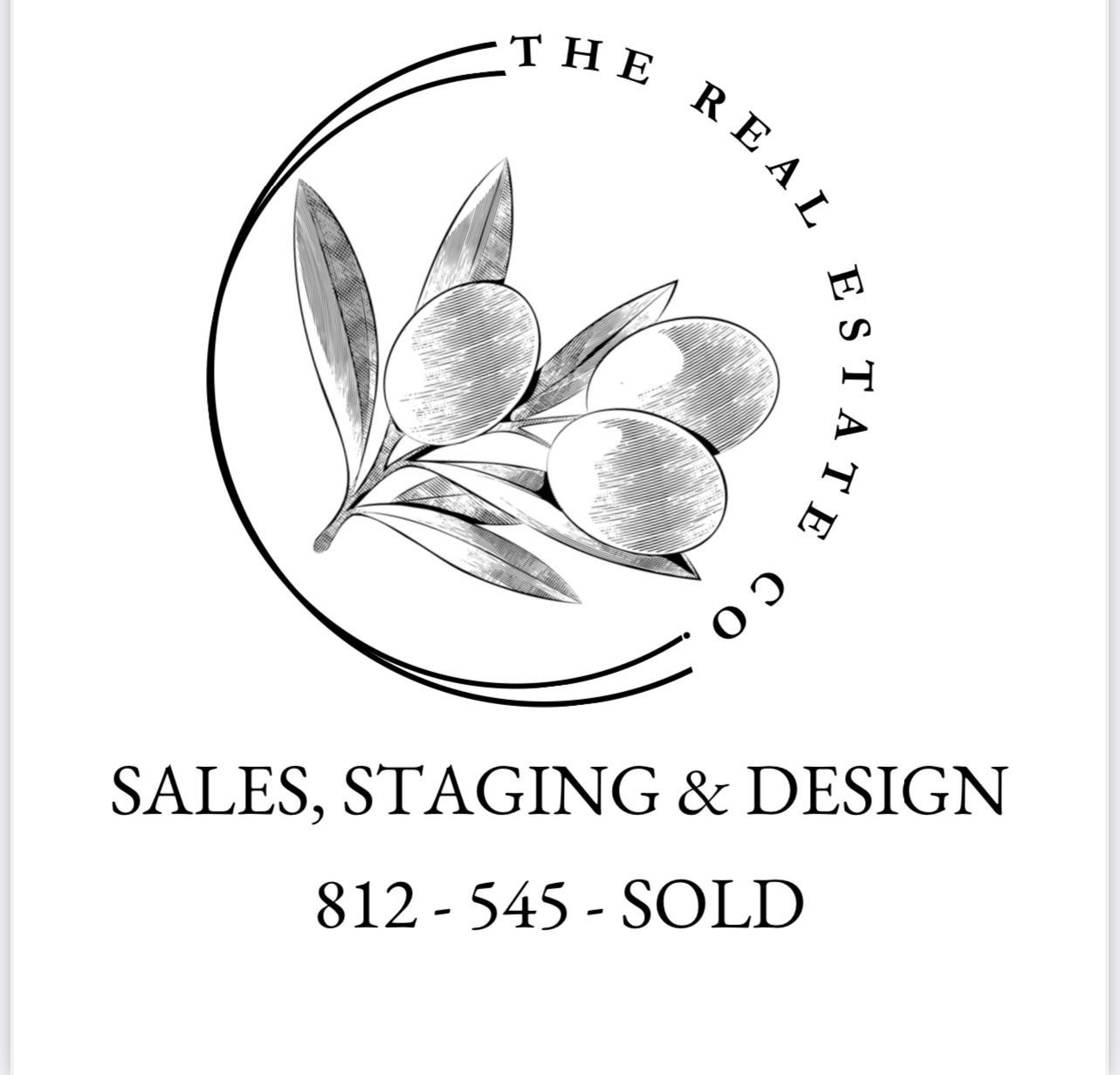 A dining room with a table and chairs and a wooden staircase.