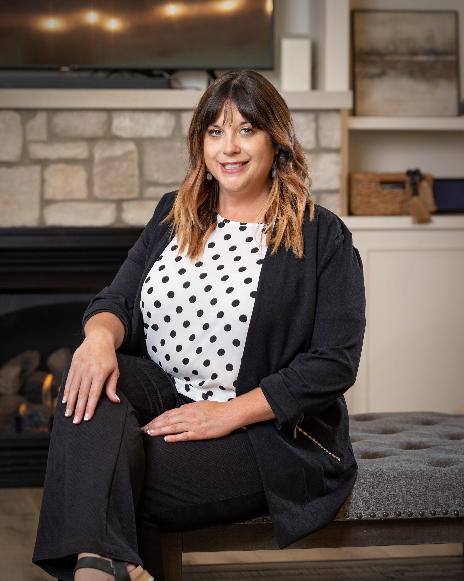 A man and two women are standing in an empty room.