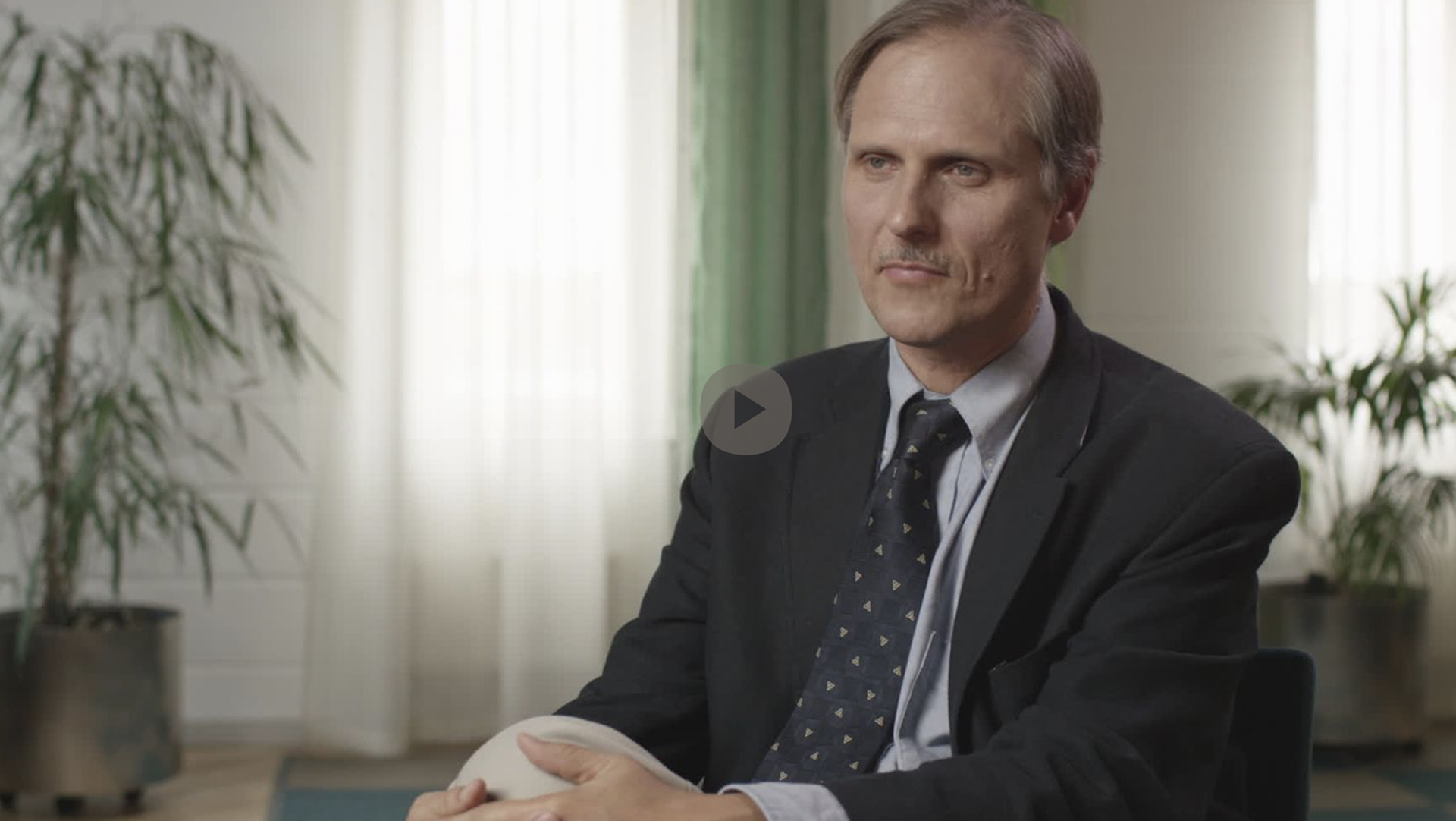 A male physician and researcher in an office.