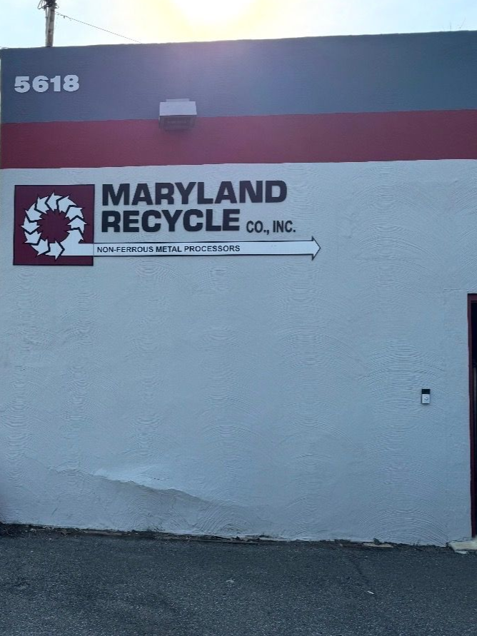 The exterior wall of Maryland Recycle Co., Inc. at 5618, featuring their logo in red, white, and dark gray.