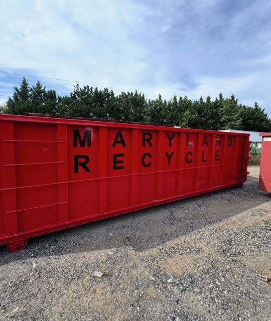 A long, bright red dumpster with 