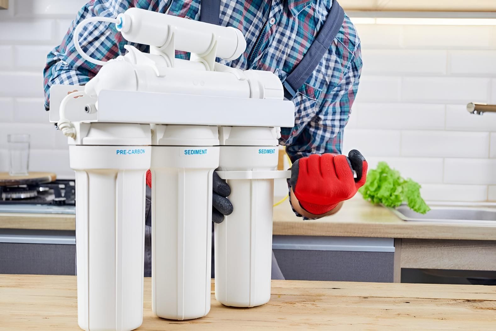 Man is Fixing a Water Filter in a Kitchen — Wet & Dry Plumbing & Gas in Newtown, QLD