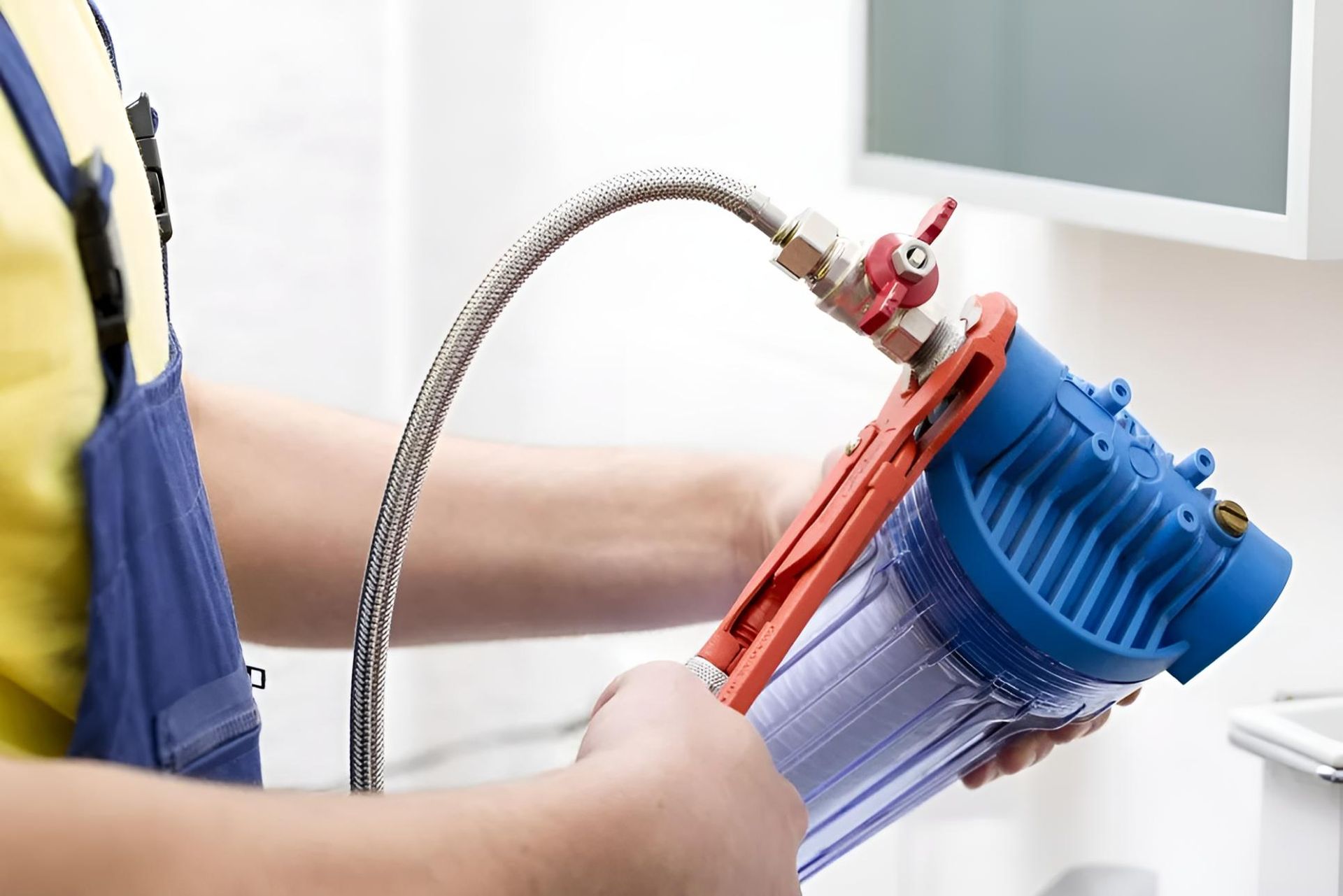 Plumber is Fixing a Water Filter With a Wrench — Wet & Dry Plumbing & Gas in Highfields, QLD
