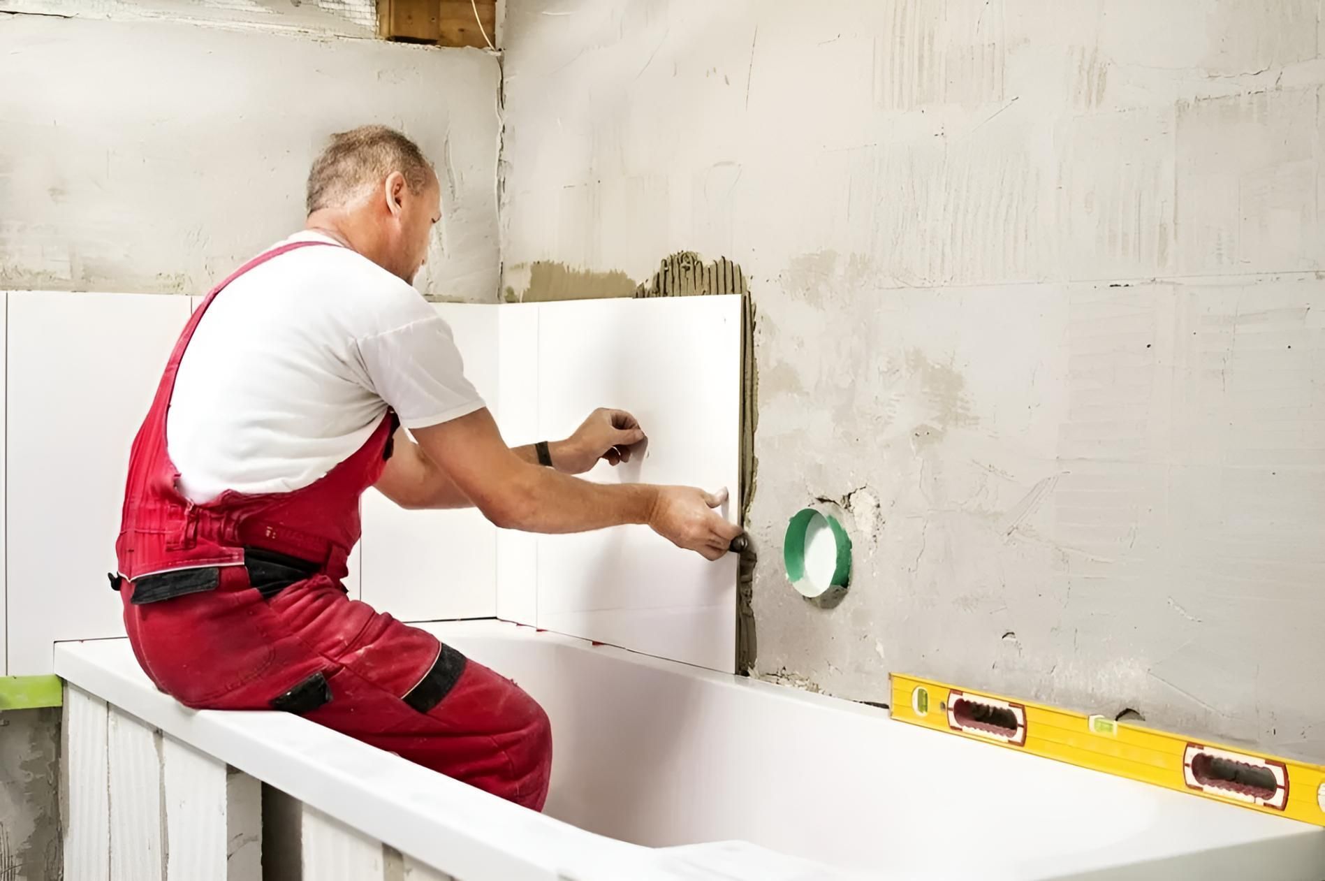 Man is Working on the Edge of a Bathtub — Wet & Dry Plumbing & Gas in Gatton, QLD