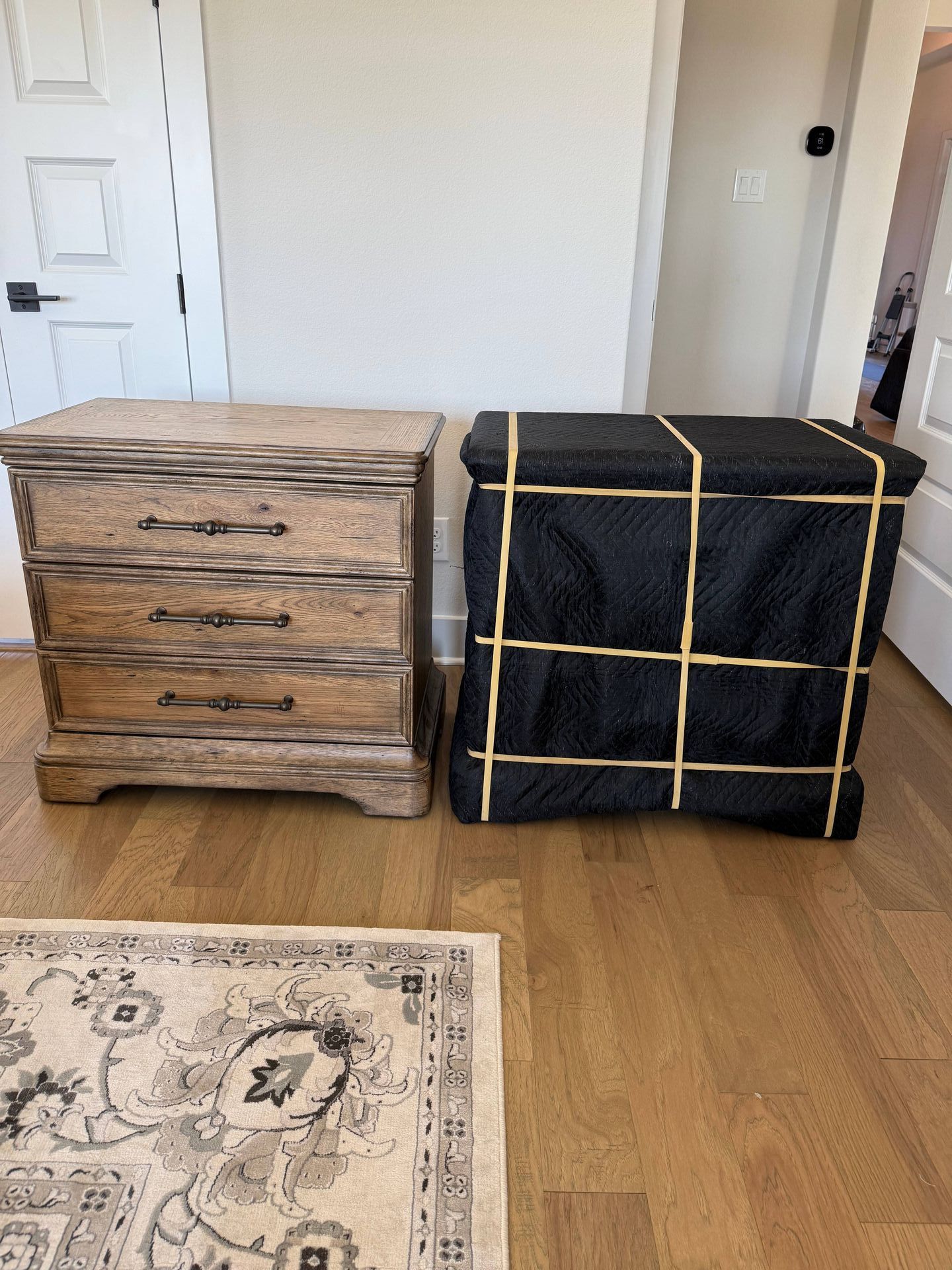 Two dressers are sitting next to each other on a wooden floor.
